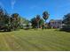 Large backyard with spacious grass area, mature trees, and a gazebo at 4715 Beach Blvd, Orlando, FL 32803