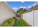 Side yard with landscaping and privacy fence at 1957 Teaberry Ct, Orlando, FL 32824