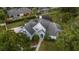 Aerial view of a two-story house with a gray roof and blue exterior, surrounded by lush landscaping at 2523 Madron Ct, Orlando, FL 32806