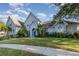 Stunning two-story home with a light blue exterior and mature landscaping at 2523 Madron Ct, Orlando, FL 32806