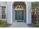 Elegant double front door with arched entryway and sidelights at 2523 Madron Ct, Orlando, FL 32806