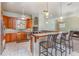 Spacious kitchen featuring wood cabinets and a breakfast bar at 2523 Madron Ct, Orlando, FL 32806