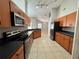 Modern kitchen with stainless steel appliances and wood cabinets at 817 Highland Crest Loop, Lake Wales, FL 33853