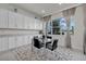 Breakfast nook with glass table and black chairs, features an area rug and large window at 7537 Wandering Way, Orlando, FL 32836