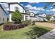 Two story house with white siding and a large driveway at 7537 Wandering Way, Orlando, FL 32836