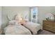 Charming bedroom with twin beds, bunny headboards, and floral bedding at 399 Eventide Ave, Mascotte, FL 34753