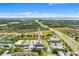 Aerial view of a commercial area with a tall tower at 399 Eventide Ave, Mascotte, FL 34753