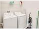 Bright laundry room with washer, dryer, and overhead shelving at 543 Ocean Course Ave, Davenport, FL 33896