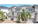 Modern three-unit townhome building with attached garages at 543 Ocean Course Ave, Davenport, FL 33896