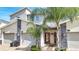 Modern three-unit townhome building with attached garages at 543 Ocean Course Ave, Davenport, FL 33896
