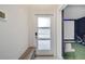 Modern entryway with a sleek door and bench at 543 Ocean Course Ave, Davenport, FL 33896