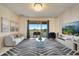 Spacious living room with a large TV, comfortable sofa, and access to balcony overlooking golf course at 543 Ocean Course Ave, Davenport, FL 33896