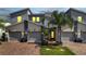 Modern three-unit townhome building with attached garages at 543 Ocean Course Ave, Davenport, FL 33896