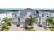 Modern three-unit townhome building with attached garages at 543 Ocean Course Ave, Davenport, FL 33896