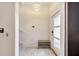 Bright and airy entryway with staircase and storage bench at 543 Ocean Course Ave, Davenport, FL 33896