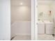 Upper-level laundry room with washer, dryer, and shelving at 543 Ocean Course Ave, Davenport, FL 33896