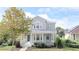 Two-story house with a gray facade, front porch, and landscaping at 7041 Buttonbush Loop, Harmony, FL 34773