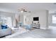 Bright living room with gray sofa and blue accent chairs at 7041 Buttonbush Loop, Harmony, FL 34773