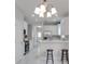 Open concept kitchen with island, stainless steel appliances, and white cabinets at 7041 Buttonbush Loop, Harmony, FL 34773