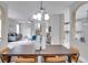 Open concept dining room, showcasing a rustic wooden table and modern light fixture at 7041 Buttonbush Loop, Harmony, FL 34773