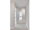 Hallway with neutral colored carpeting and access to bedrooms at 7041 Buttonbush Loop, Harmony, FL 34773