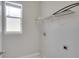 Laundry room with overhead shelving and a window for natural light at 7041 Buttonbush Loop, Harmony, FL 34773