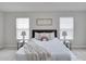 Main bedroom with a plush bed and plenty of natural light at 7041 Buttonbush Loop, Harmony, FL 34773