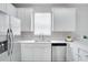 Modern kitchen featuring white cabinets, stainless steel appliances, and a quartz countertop at 7041 Buttonbush Loop, Harmony, FL 34773