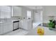 Modern kitchen with white cabinets, stainless steel appliances, and quartz countertops at 7041 Buttonbush Loop, Harmony, FL 34773