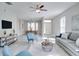 Open concept living room with gray sofa and blue accent chairs at 7041 Buttonbush Loop, Harmony, FL 34773