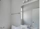 Simple bathroom with a large mirror, toilet and sink at 7041 Buttonbush Loop, Harmony, FL 34773