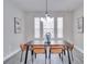 Dining room with brown table and tan chairs, and a chandelier at 7041 Buttonbush Loop, Harmony, FL 34773