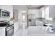 Modern kitchen featuring stainless steel appliances and white cabinetry at 7041 Buttonbush Loop, Harmony, FL 34773