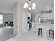 Open concept kitchen and living room with white cabinets and stainless steel appliances at 7041 Buttonbush Loop, Harmony, FL 34773