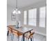 Dining room with brown table and tan chairs, and a chandelier at 7041 Buttonbush Loop, Harmony, FL 34773