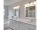 Double vanity bathroom with quartz countertops and ample storage at 7041 Buttonbush Loop, Harmony, FL 34773