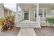 Inviting front porch with white railings and a gray door at 7041 Buttonbush Loop, Harmony, FL 34773