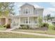 Two story home with front porch and landscaping at 7041 Buttonbush Loop, Harmony, FL 34773