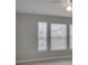 Bright bedroom with three windows and neutral wall colors at 7041 Buttonbush Loop, Harmony, FL 34773