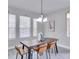 Dining room with brown table and tan chairs, and a chandelier at 7041 Buttonbush Loop, Harmony, FL 34773