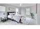 Main bedroom with a plush bed and plenty of natural light at 7041 Buttonbush Loop, Harmony, FL 34773