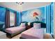 The Little Mermaid themed bedroom with twin beds and ocean mural at 3955 Lana Ave, Davenport, FL 33897