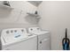 Laundry room with Whirlpool washer and dryer, plus shelving at 3955 Lana Ave, Davenport, FL 33897
