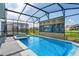 Screened pool and spa with a decorative wall feature at 3955 Lana Ave, Davenport, FL 33897