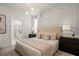 Bright main bedroom with a king-size bed, ensuite bathroom access, and ample natural light at 3955 Lana Ave, Davenport, FL 33897