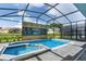 Screened pool and spa with a decorative wall feature at 3955 Lana Ave, Davenport, FL 33897