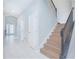 Elegant staircase with a wooden handrail and black spindles at 5045 Rain Shadow Dr, St Cloud, FL 34772