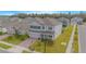 Two-story house with gray exterior, a brick driveway, and a landscaped lawn at 5045 Rain Shadow Dr, St Cloud, FL 34772
