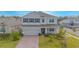 Two story house with paver driveway and front yard at 5045 Rain Shadow Dr, St Cloud, FL 34772