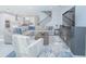 Large living room with sectional sofa, wood coffee table and stairs to upper level at 5045 Rain Shadow Dr, St Cloud, FL 34772